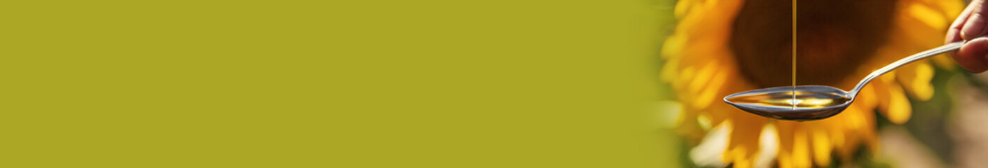 Sunflower oil in a spoon on the field. Selective focus.