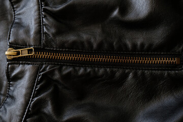 Black leather fabric with zippers, background. Fashion design detail