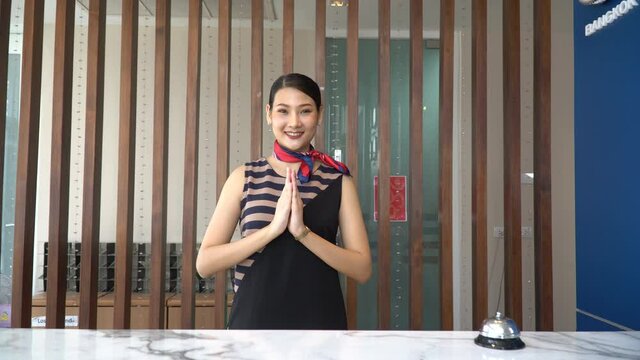 thai receptionist welcome and greeting with Thai wai at hotel thailand