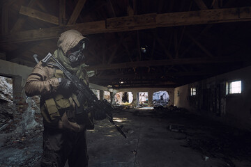 man in gas mask wandering through abandoned settlement.