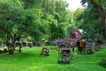 Old agricultural machines in the courtyard of the farm 