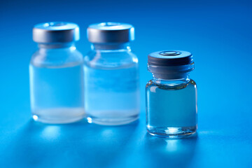 vaccine bottle on the blue background