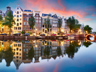 Naklejka premium Sunset city view of Amsterdam, the Netherlands with Amstel river