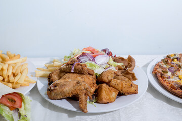 Fried chicken served with donner meat, chicken tikka and salad, with Vegetarian pizza and wrap – fast food Sheffield UK
