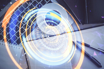 Technology hologram drawing over computer on the desktop background. Top view. Double exposure. Tech concept.