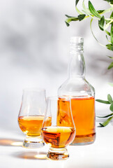 Scotch Whiskey in special glasses and bottle, white background with negative space
