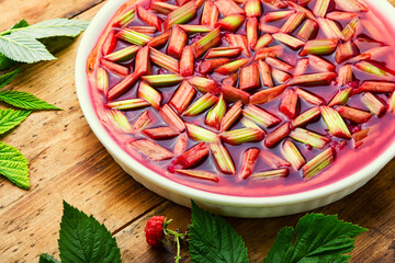 Pie with rhubarb and raspberries on old wooden background