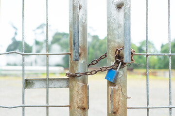 blue padlock on the fence. padlock on rustic steel gate
