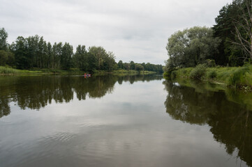 Fototapeta na wymiar calm river on a cloudy day, landscape