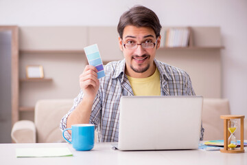 Young male designer working from house
