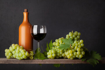 Fototapeta na wymiar White grape, bottle and red wine glass