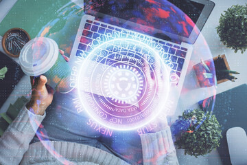 Double exposure of woman hands working on computer and tech theme hologram drawing. Top View. Technology concept.