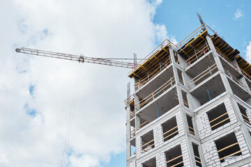 Low angle shot of residential building under construction with brick and concrete structure against...