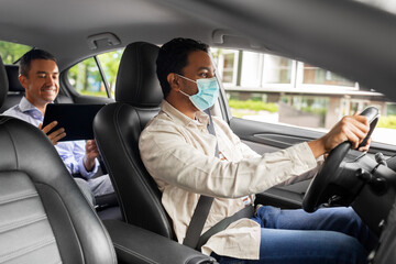 transportation, health and people concept - indian male taxi driver driving car with passenger wearing face protective medical mask for protection from virus disease