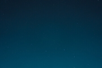 Fototapeta na wymiar Starry night sky with many stars on blue background