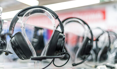 Headphones on stands put up for sale in a store