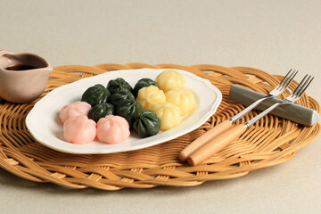Three Color Kkultteok is Ball Shaped Rice Cake Filled with Honey and Sesame Syrup, Korean Traditional Cake for Chuseok Day. Concept Korean Culture