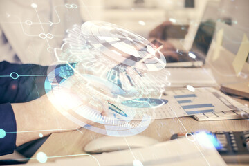 Double exposure of man's hand holding and using a digital device and data theme hologram drawing. Technology concept.