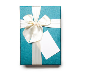 Blue gift box with empty white blank gift tag mock up. Christmas, birthday or wedding gift. Isolated background
