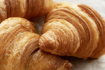 Fresh beautiful French croissants with jam on craft paper.