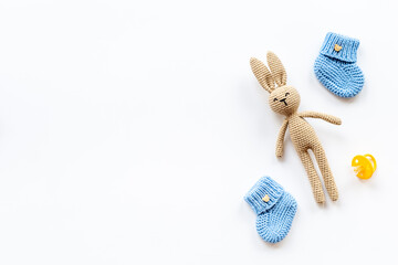 Knitted baby toy rabbit with newborn booties shoes, top view