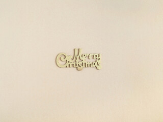 Merry Christmas gold greeting message on beige background.