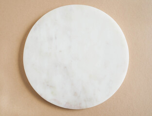 Marble white podium on beige background.