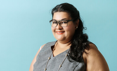 portrait plus size latin american businesswoman looking at camera. business and finance concept.