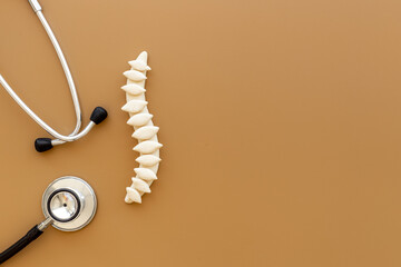 Treatment of osteochondrosis - medical spine model with stethoscope