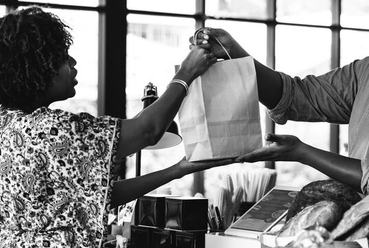 Black customer buying bakery products