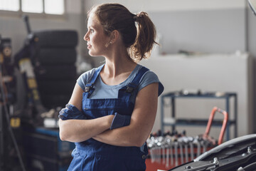 Portrait of female mechanic in the auto repair shop