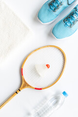 Competitive sports equipment. Two badminton rackets and shuttlecock with towel and water