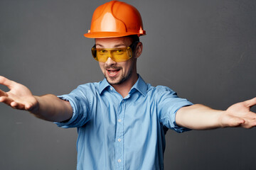man in working uniform yellow glasses construction posing