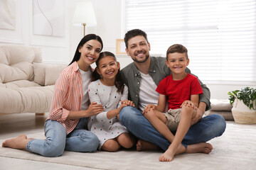 Portrait of happy family in living room. Adoption concept
