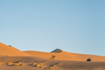Fototapeta na wymiar The sunset view of the dunes in deserts in Dunhuang, China.