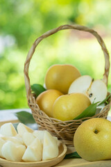 Fresh Snow pear fruit in Bamboo basket on blurred greenery background, Fresh pear fruit in the basket on natural farm.