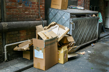 A city laneway filled with boxes and garbage