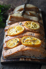 Cooked salmon fillet on a wooden cedar board. Recipes for grilling.