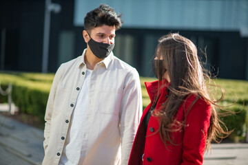 Couple walking in a city during covid or coronavirus pandemic