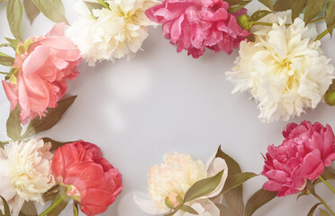 Beautiful red, pink and white peony flowers bouquet over pink background, toned image, top view, copy space, flat-lay. Valentines, Wedding and Mothers day background.