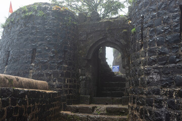 View of top entrance gate of the fort during rain, Tikona Fort, Pune, Maharashtra, India.