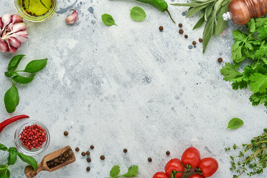 Food Cooking Background. Fresh Saffron, Garlic, Cilantro, Basil, Cherry Tomatoes, Peppers And Olive Oil, Spices Herbs And Vegetables At Light Grey Slate Table. Food Ingredients Top View.