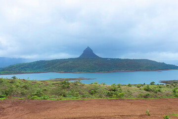 Fototapeta premium View of Tung fort from Pawna dam view point, Pune, Maharashtra, India,