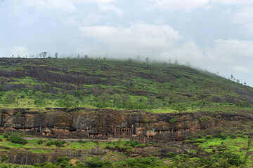 Vew of Lenyadri cave facade during rainy season, Pune, Maharashtra, India.