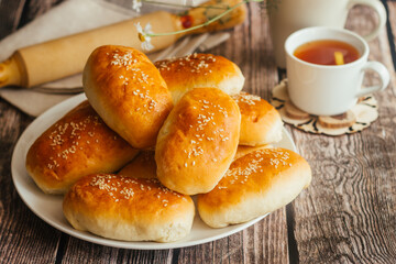 Pies with onions and eggs. Russian national dish. Delicious pies on a wooden table 