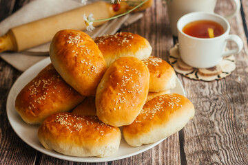 Pies with onions and eggs. Russian national dish. Delicious pies on a wooden table 