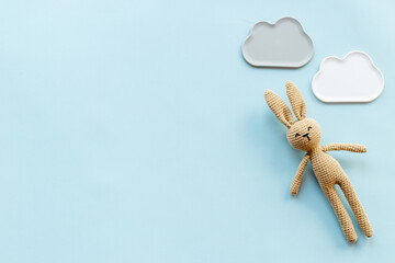 Knitted baby toy rabbit for newborn - background for baby shower
