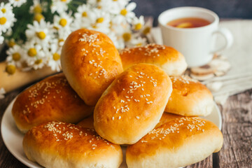 Pies with onions and eggs. Russian national dish. Delicious pies on a wooden table 