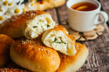 Pies with onions and eggs. Russian national dish. Delicious pies on a wooden table 
