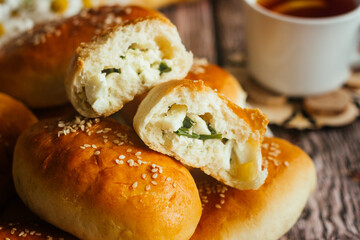 Pies with onions and eggs. Russian national dish. Delicious pies on a wooden table 